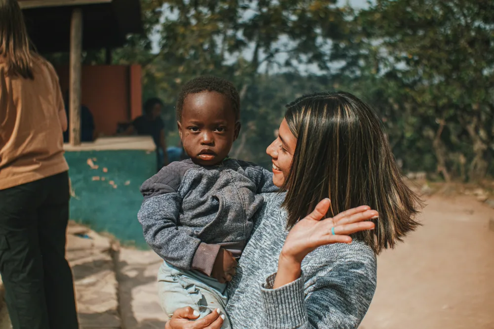 A woman smiling with a young child.