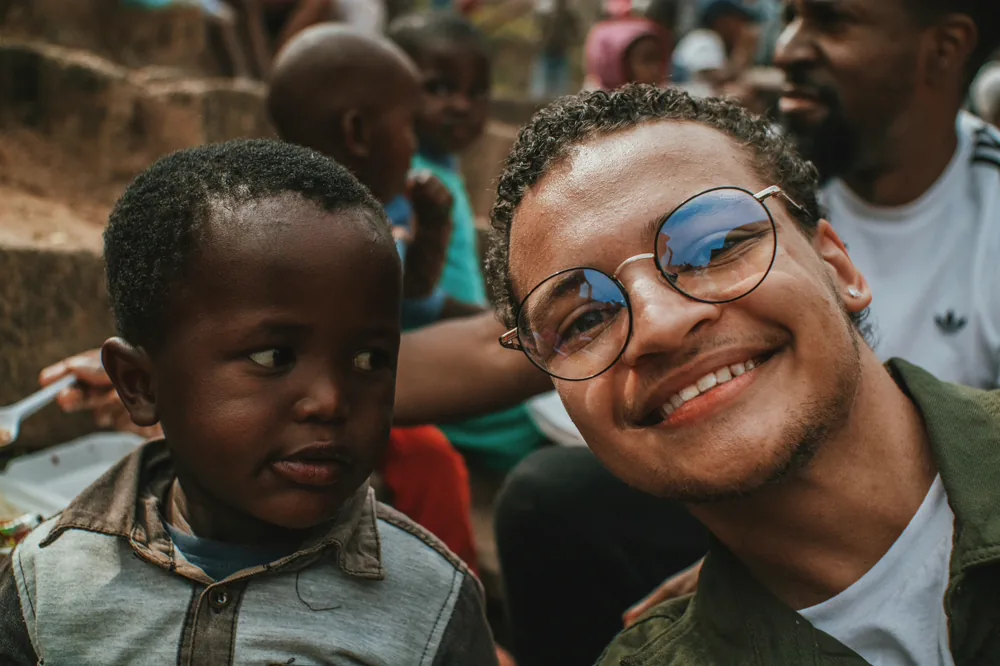 A father and his young son smiling together.