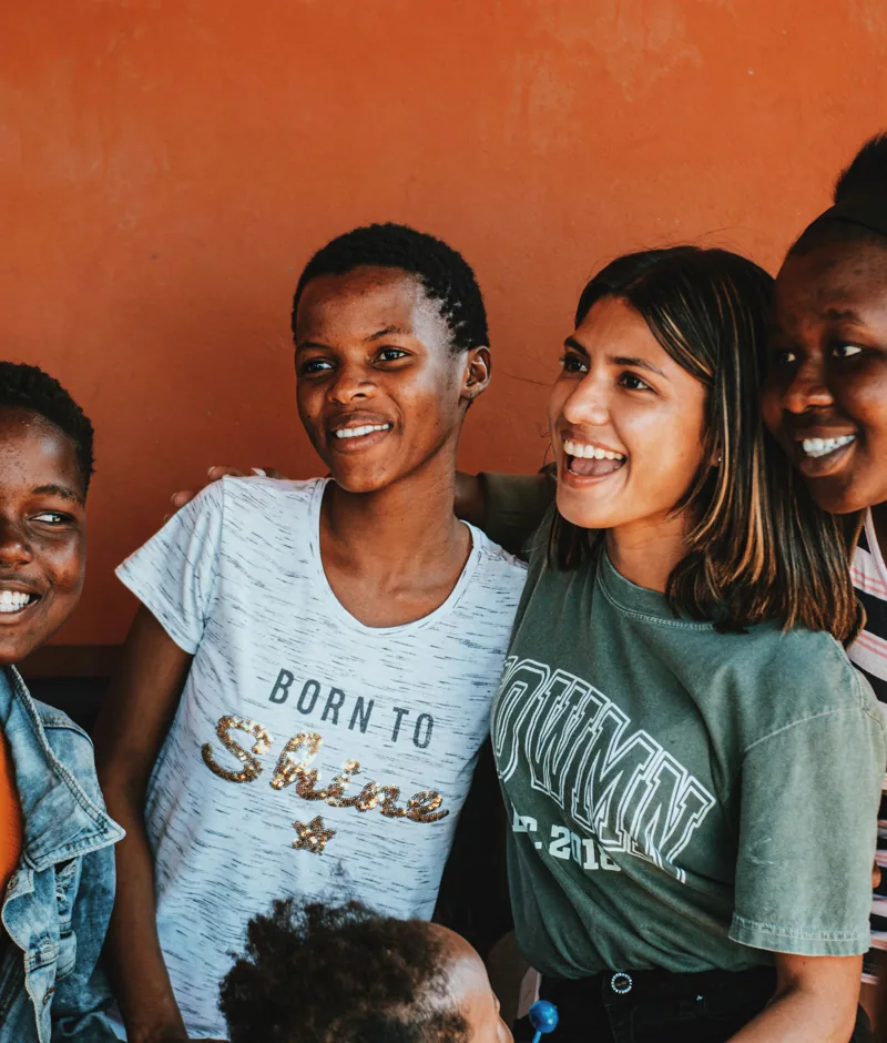 A group of young people smiling together.