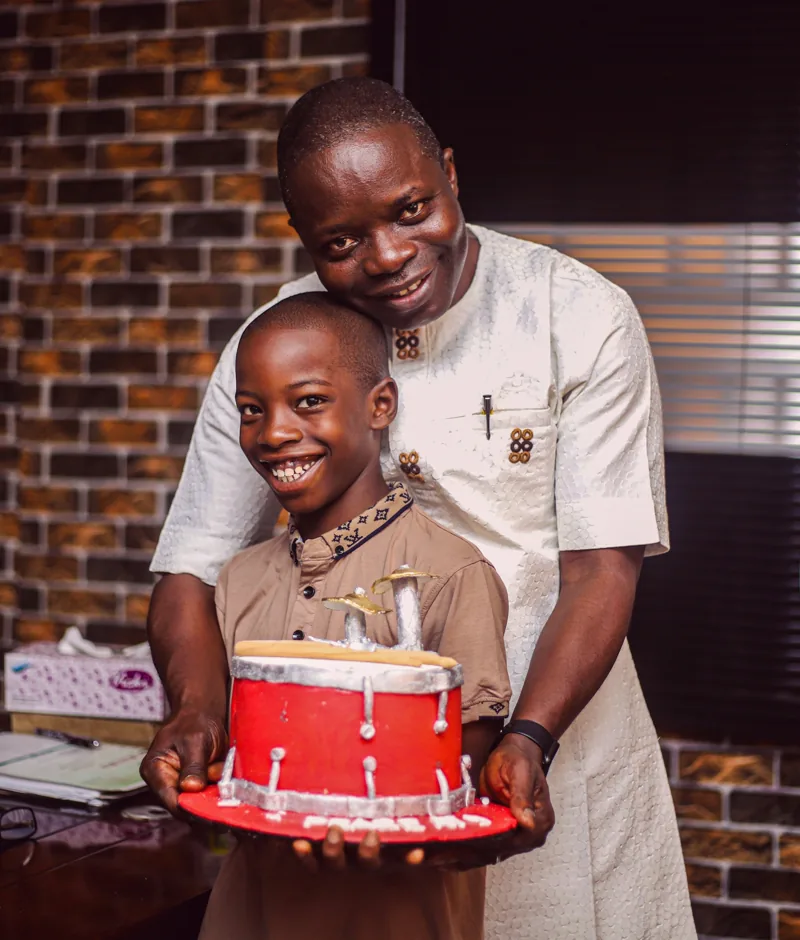 A father and son smiling together.