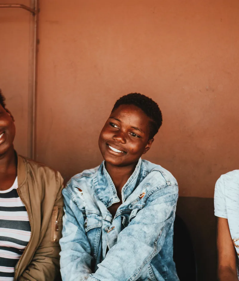 A group of young people smiling together.